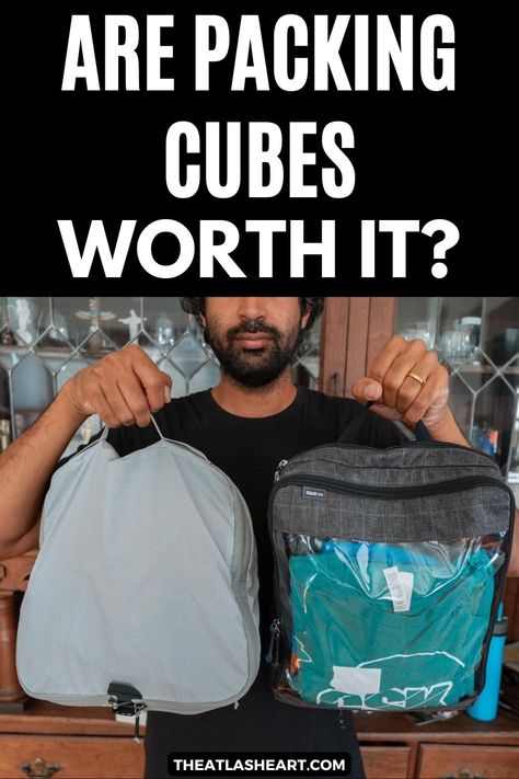 A picture of a man taken at chest level as he holds up two different styles of packing cubes with a wooden cabinet behind him, with the text overlay, "Are Packing Cubes Worth It?" How To Use Packing Cubes, Packing Cubes How To Use, Best Packing Cubes, Suitcase Packing Tips, Cruise Packing, Travel Cubes, Travel Necessities, Packing For A Cruise, Best Luggage