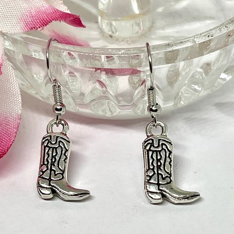 Exquisite! Captivating! Elevate your style with Dainty Silvery Cowboy Boot Dangle Earrings, available for a limited time at the incredible price of $10.00 #LightWeight #CharmingDelicate #SilverEarrings #CowgirlEarrings #DangleDropSilver #WesternJewelry #ComfortableToWear #RodeoAccessory #CowboyBoot #UniqueAccessory Boot Earrings, The Old West, Western Jewelry, Cowboy Boot, Etsy Earrings Dangle, Old West, Accessories Unique, Western Style, Rodeo