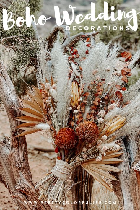 Tie the knot with a whimsical boho wedding. Decorate your outdoor wedding with my selection of 30 boho wedding decorations on a budget. Walk down the aisle to the love of your life on boho rugs, rustic chic floral aisle decorations, and a dried flower wedding bouquet. Celebrate your love with an outdoor wedding reception with boho centerpieces featuring dried floral arrangements and fresh flowers. Click the link to discover gorgeous bohemian wedding decorations. Boho Fall Centerpieces Wedding, Boho Chic Wedding Reception Decor, Boho Wedding Pew Decor, Rustic Bohemian Wedding Table Decor, Boho Wedding Centerpieces Diy Wedding Table Decor, Boho Table Flower Arrangements, Boho Flower Centerpieces Wedding, Boho Rustic Flower Arrangements, Boho Chic Wedding Arch