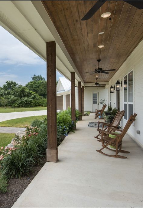 One Story Front Porch Ideas, Wrap Around Porch Makeover, Full Length Covered Front Porch, Wrap Around Porch Concrete, Dark Cedar Posts Front Porch, Farmhouse Porch Flooring, Long Covered Front Porch Ideas, Fireplace On Front Porch, Bardominum Ideas Front Porch