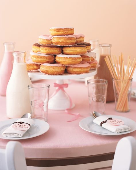 Here's a décor idea that's adorable and edible: Forgo a floral centerpiece at a bridal shower brunch (or at the kids table at a wedding) and opt for an impressive display of chocolate, strawberry, and vanilla donuts—with icing and bottles of milk to match! Tip: Flattened paper cupcake liners between donuts will keep the snacks from sticking together.