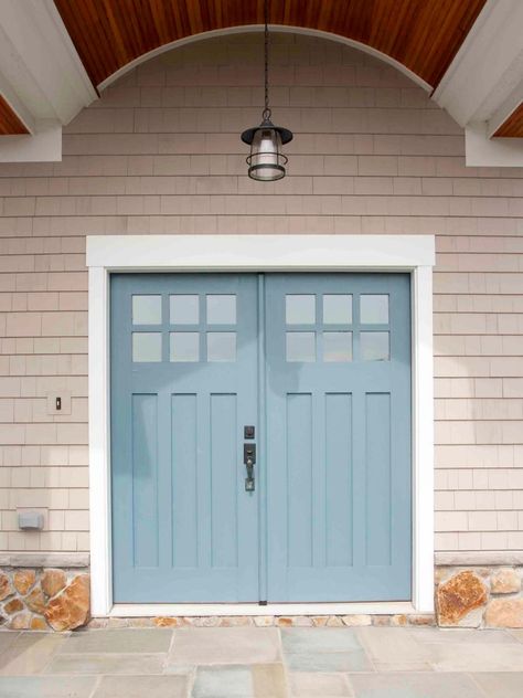 This cool grayish-blue (Behr’s Oslo Blue) makes a great complementary pairing with the warm neutral palette of the surrounding house. The color also echoes the soft blues on the stone porch. Curb Appeal Porch, درابزين السلم, Tan House, Blue Front Door, Blue Doors, Front Door Paint Colors, Door Colors, Door Paint Colors, Double Front Doors