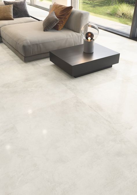 Casalgrande Padana’s Kerinox Bianco lapped tiles embody the reflective nature of metal, brightening this open-plan living area. Floor Tiles Living Room Modern, Living Room Floor Tiles, Room Floor Tiles, Modern Floor Tiles, Laundry Room Tile, Floor Tiles Design, Tiles Living Room, Tile Floor Living Room, Modern Flooring