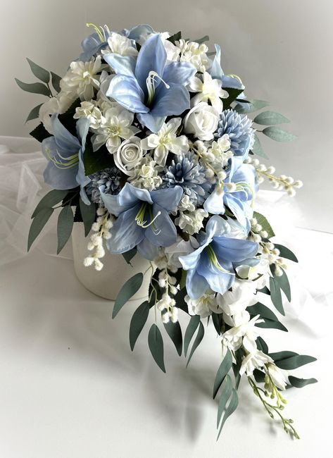 Pale Blue lilies , dusty blue dahlias , white peony , white roses , lilac , wattles , delphiniums , camellia foliage , eucalyptus  Cascading bridal bouquet . Finish with white ribbons  Bouquet is 50 cm (20inch) long and 32 cm (12inch) across. Bridesmaids matching lowers with white ribbons  Groom buttonhole Groomsmen buttonholes   cake topper set x 3 Wedding Bouquets Iris, Dark Blue Wedding Flowers, White And Blue Wedding Bouquet, Light Blue Wedding Bouquet, Cinderella Bouquet, Baby Blue Bouquet, Stargazer Lily Wedding Bouquet, Lilly Bouquets, Dusty Blue Wedding Flowers