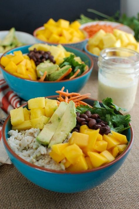 Escape to a warm, tropical destination with this Tropical Coconut Rice Bowl.  Sweet coconut Rice is topped with fresh tropical fruit, black beans, cilantro, avocado and a creamy pineapple dressing making this a nice vegetarian lunch or dinner option. // acedarspoon.com #ricebowl #coconut #vegetarian Tropical Fruit Bowl, Tropical Rice Bowl, Cocnut Rice, Coconut Rice Bowl, Pineapple Rice Bowl, Pineapple Dressing, Sweet Coconut Rice, Tropical Rice, Tropical Bowl