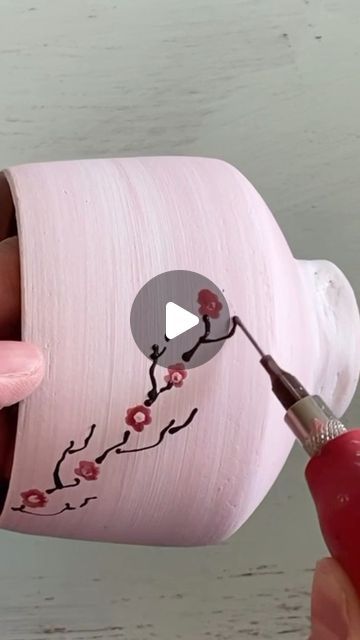 Anne Egitto on Instagram: "Painting cherry blossoms on porcelain using underglaze. The background is a mix of red and white underglazes and the cup will be finished with clear glaze on the outside and white glaze on the inside. Shop updat coming soon dates in profile 🌸💕 . . . . #reels #potteryreels #potterymaking #ceramicvideosofinstagram #ceramicvideos #potteryvideosofinstagram #potteryvideo #calmingart #calmingsounds #satisfying #handpaintedpottery #holidayshopping" Porcelain Painting Techniques, Paint Pot Ideas, Ceramic Painting Inspiration, Hand Painted Pottery Bowls, Paint Your Own Pottery Ideas Easy, Ceramic Cup Painting Ideas, Underglaze Painting On Pottery, Painting Cherry Blossoms, Clay Glazing