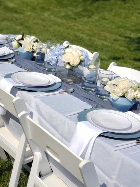 Create an upscale outdoor partyscape with a stylish table setup using cool dusty blue and white décor supplies. Spruce up the table with a white polyester tablecloth and blue gauze cheesecloth table runner to create a chic vibe. Add white polyester linen napkins to the look of the plates and decorate the table with dripless floating candles and artificial cream silk peony florals. Opt for our white padded folding chairs for an added flair. Navy Blue Wedding Colors, Modern White Table, Event Table Settings, Event Decor Ideas, Party Decorations Table, Cheesecloth Table Runner, Padded Folding Chairs, Outdoor Table Decor, Baby Shower Giraffe