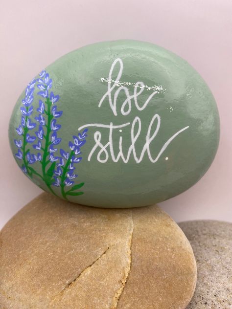 This hand-painted rock is a one-of-a-kind work of art. I use acrylic paint and all lettering and graphics are free-hand. The rock is protected with a sealant to make it suitable for indoor and outdoor purposes. Community Rock Garden, Landscape Rock Painting Ideas, Painted Rocks With Words, Painted Rocks Positive Sayings, In Memory Painted Rocks, Fairy Garden Rocks, Rock Painting Ideas Quotes, Plant Rock Painting, Bible Verse Rock Painting