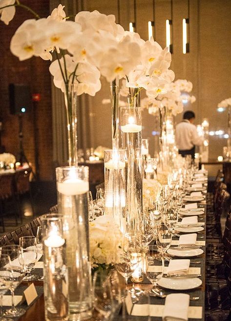 tall orchid wedding centerpiece idea via A Day of Bliss Photographya / http://www.himisspuff.com/tall-wedding-centerpieces/12/ Amazing Wedding Centerpieces, Tall Glass Vases, Flowers And Candles, Orchid Centerpieces, Tall Wedding Centerpieces, Wedding Reception Ideas, Winter Wedding Flowers, Orchid Wedding, Spring Wedding Flowers