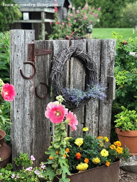 Tour a Country Garden at the Farm - Town & Country Living Rustic Fences And Gates, Farm Style Garden Ideas, Old Wooden Gates Ideas, Farm Yard Landscaping Country Living, Rustic Fence Ideas Country Living, Rustic Driveway Entrance, Rustic Shelves Diy, Old Garden Gates, Landscape Decorations