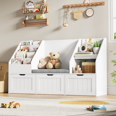 This stylish children's cube bookcase is crafted from high-quality P2 MDF board and finished with a sleek, environmentally friendly paint. With its 4-layer bookshelves and cushioned seating area, it's the perfect solution for organizing books, magazines, toys, and more. The included toy storage box features 3 large removable drawers on 360-degree rotating wheels, making it easy for children to keep toys, games, clothes, and more neatly organized. Additionally, it can be used to display art decor Book And Toy Storage Ideas, Kids Toys Storage Ideas, Bookshelf Reading Nook, Baby Book Shelf, Organise Toys, Toy Room Ideas, Baby Bookshelf, Reading Bench, 2 Shelf Bookcase