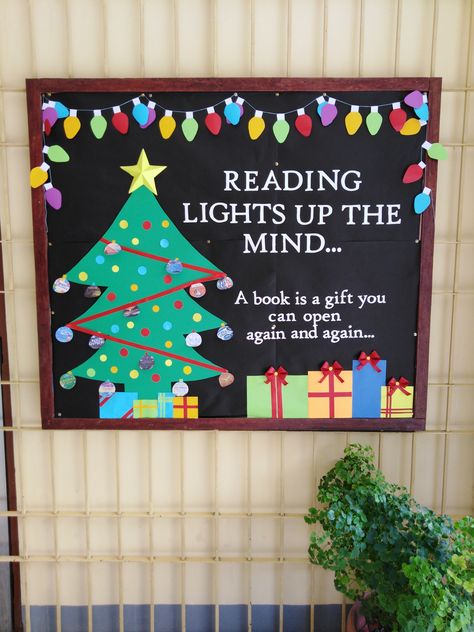 Reading Lights Up The Mind Bulletin Board, Christmas Decor Ideas In Library, Library Bulletin Board Ideas Christmas, Christmas Book Fair Ideas, Christmas Book Themed Door Decorations, Reading Christmas Bulletin Boards, Christmas Bulletin Board Ideas For Library, Christmas Bulletin Board Idea, Christmas Reading Bulletin Board Ideas