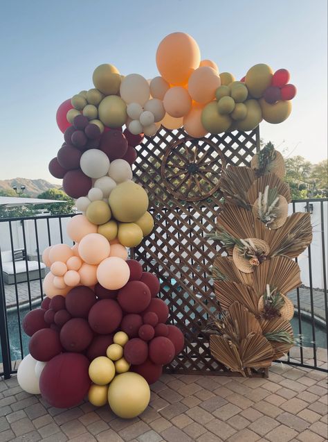 This Country Chic themed balloon backdrop was perfect for this 40th birthday party! I created a dried palm leaf wall with floral pops to add dimension and color. The colors I used are maroon, sand white, gold and retro apricot. And the wagon wheel was just what it needed to give it that Country feel! Chic Balloon Garland, 40th Birthday Party, Leaf Wall, Balloon Backdrop, 40th Birthday Parties, Wagon Wheel, Cat Birthday, Palm Leaf, Country Chic