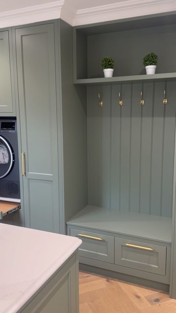 Trevor McDonnell Kitchens on Instagram: "The utility room at the “ Brookhill house project “  . . . We love the boot bench and the raised washer & dryer in this utility room. it made life for our clients so functional  . . A green utility room with raised washing machine and dryer combines practicality with a fresh, vibrant aesthetic. The green color palette, ranging from soft sage to rich emerald, infuses the space with a sense of calm and connection to nature.  The washing machine and dryer are elevated on sturdy platforms, making them easily accessible without the need to bend down, which enhances ergonomic convenience. These platforms often include built-in storage drawers underneath, perfect for housing laundry detergents, fabric softeners, and other cleaning supplies.  Cabinetry in c Cleaning Supply Storage Laundry Room, Sage Utility Room, Raised Washing Machine, Sage Laundry Room, Raised Washer Dryer, Green Utility Room, Utility Room Inspiration, Boot Bench, Utility Space