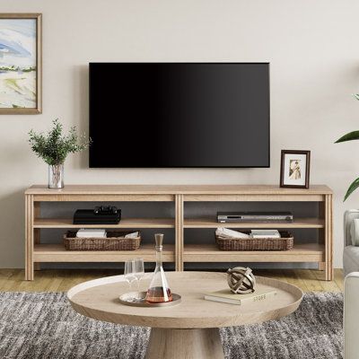 Keep your living room decor simple with the 70-inch TV Stand for TVs up to 75". The media console features the collection's signature low-profile design with clean lines, open space, and a sturdy structure. This basic design will easily blend into your living room layout and pair well with the room's other decor for a finished. The TV Stand also has wide, open shelf space to store media devices, gaming systems, and other TV components. Color: Oak | Red Barrel Studio® Lyndale TV Stand for TVs up Tv Console For 85 Inch Tv, Low Tv Stand Decor, Tv Stand Open Shelves, Media Console Living Room Decor, Light Oak Living Room Ideas, Cozy Living Room Tv Stand, Light Brown Tv Stand, Open Tv Stand Decor, Tv Stand For 75 Inch Tv