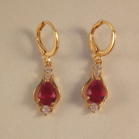 These Beautiful Red Pear Shape Topaz Zircon Earrings Are Made Of 18k Yellow Gold Filled. The (Lab Created) Red Topaz Zircon Stones Are 6x8mm With Small White Topaz Stones. Brand New And Never Been Worn. Lead And Nickel Free. These Fine Quality Earrings Are Perfect And Comfortable All Day, Everyday Wear, Special Occasions, Or A Special Gift. Please Send Offers And Questions. Stone :6 X 8mm Or .24" X .31" Earrings: 31 X 9mm Or 1.22" X .35" Hoop Dia: .43" Fastening: Hoop Clasp (Pierced) Red Gem Jewelry, Red And Gold Earrings, Gold And Red Jewelry, Gold And Red Earrings, Red Gold Jewelry, Gold Ruby Earrings, Purple Heart Earrings, Gold Jewelry Prom, Red Topaz