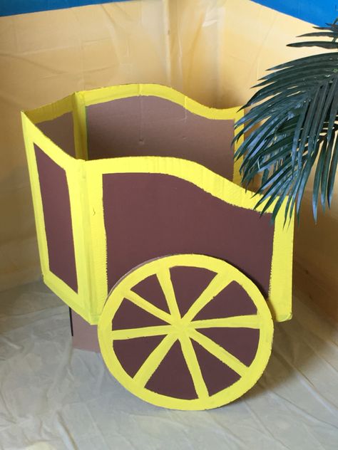 Cardboard chariot Diy Chariot Projects, How To Make A Chariot Out Of Cardboard, Elijah Vbs Decorations, Ancient Rome Decorations, Ancient Greece Birthday Party, Roman Decorations Party, Ancient Greece Decorations, Ancient Greece Decor, Ancient Rome Party