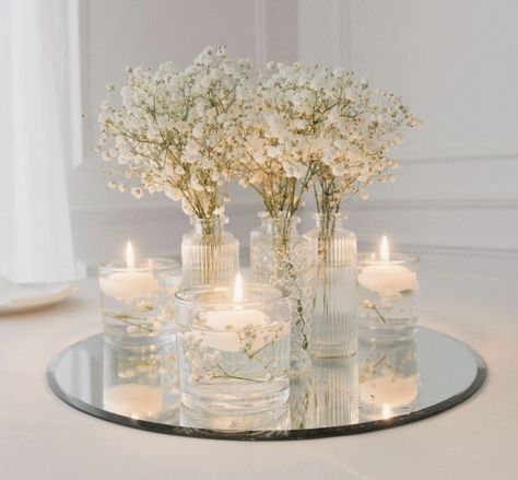 Baby's Breath And Candles Centerpiece, Wedding Glam Decor, Mirror Wedding Table Decor, Wedding Table Decorations Round Tables Candles, Simple Elegant Flower Centerpieces, Homemade Centerpieces Wedding, Wedding Round Centerpieces, Simple Wedding Centrepieces Round Tables, Simple Flower And Candle Table Decor