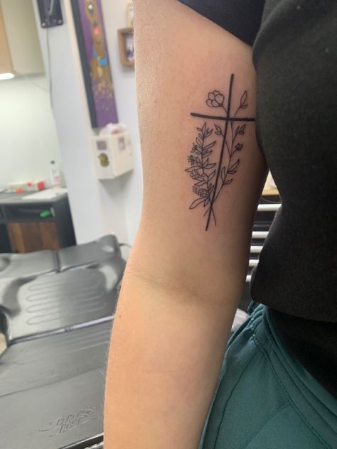 Women Biceps Tattoo, Cross And Floral Tattoo, Cross On Bicep Tattoo, Flower Western Tattoo, Bible Verse Flower Tattoo, Cross Flowers Tattoo, Birth Flower Cross Tattoo, Sidearm Tattoos For Women, Bicep Cross Tattoo