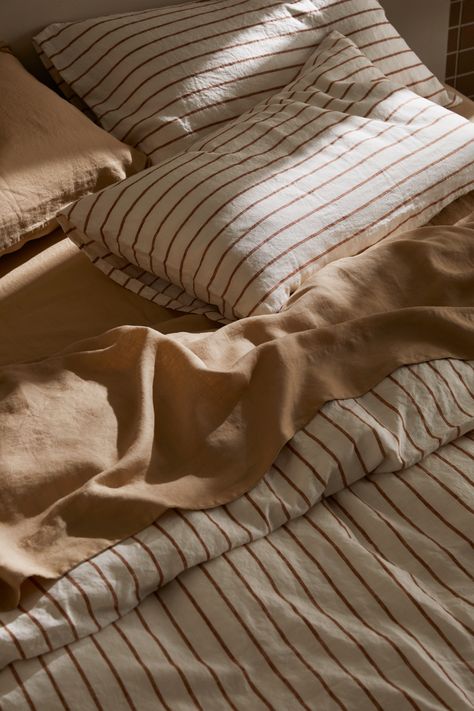 Express your style by mixing our 100% linen bedding colors. Crafted from European flax and pre-washed for unparalleled softness and durability, our collection offers a versatile palette of modern shades. Teracota Interior Bedroom, Bed Sheet Photography, Striped Sheets Bedroom, Bedroom Linens Bedding, European Pillows On Bed, Striped Bedding Ideas, Linen Sheets Bedroom, Caravan Styling, Bed Linen Styling