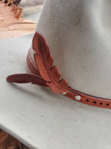 The Feather 🪶 Hat Band  ready to ship! What better way to wear feathers on a hat band and never worry about losing them or breaking them as they are so delicate. 100% leather 1/2" inch wide 2 hand carved leather feathers that can be adjusted up and down  Hand tooled design 54'' to 61" cm  shipping includes tracking and insurance Style# 1509-00 Feather Hat Band, Leather Feathers, Western Hat, Leather Ideas, Leather Hat, Hat Accessories, Feather Hat, Western Hats, Leather Hats