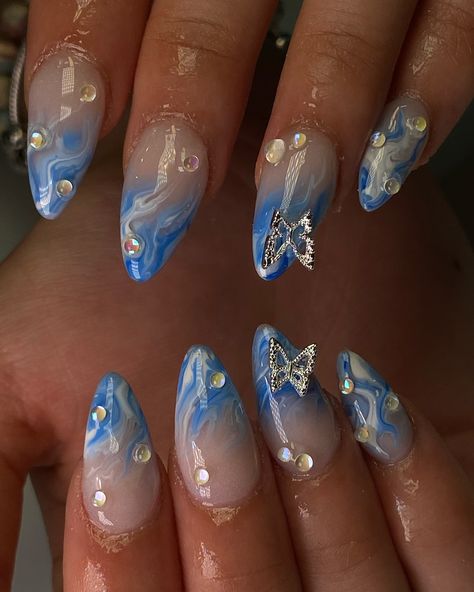 Summer blue marble 🦋💦🩵 Blue And Gold Nails Acrylic, Blue Gel X Nails, Blue Acrylic Nails Almond, Butterfly Nails Blue, Nail Designs For School, Marble Design Nails, Almond Nails Designs Summer, Cloud Nails, Cute Almond Nails