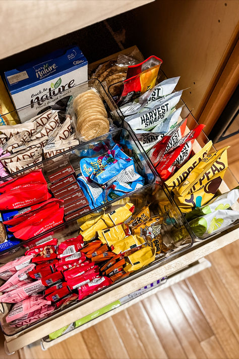 Our unruly snack drawer is now a thing of beauty thanks to unboxing the snacks into clear plastic containers. See more on the blog! Desk Snacks Drawer Healthy, Snack Containers For Pantry, Snack Set Up, Healthy College Snacks Dorm Food Mini Fridge, Healthy Snack Drawer In Bedroom, Office Snacks Drawer, Snack Cupboard Organization, Diy Snack Containers, Dorm Snacks Storage