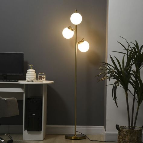 Introducing our 3-Light Multi-Head Floor Lamp, a sleek and modern lighting solution that adds charm and brightness to any room. This floor lamp features a slimline pole with three globe lampshades stemming off, creating a stylish and eye-catching design that complements various spaces, including the living room, office, and bedroom. With three bright light sources, this reading lamp provides ample illumination that easily fills the entire room. Whether you need focused lighting for reading or a well-lit space for other activities, this lamp delivers on brightness and functionality. Using the lamp is effortless with the on/off foot switch conveniently placed on the electrical cord. You can easily turn the lamp on or off, even when your hands are full. The lamp comes with a long 5.9 ft. powe Living Room Tree, Bedside Floor Lamp, Floor Lamps For Living Room, Modern Standing Lamps, Lamps For Living Room, Tree Floor Lamp, Gold Floor Lamp, Tall Lamps, Modern Floor