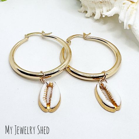 New listing! 18K gold plated hoops with Cowrie Shell! Shell is removable! Simple, Classy Summer Earrings! Hoop diameter is 1.375”. https://myjewelryshed.etsy.com/listing/1728839967/18k-plated-cowrie-shell-hoop-earrings #cowrieshelljewelry #cowrieshells #cowrieshellearrings #hoopearrings #goldhoops #summerjewelry #beachearrings #beachjewelry #bohobeach #etsy #myjewelryshed #resortvibes #resortwear #vacationjewelry Shell Hoop Earrings, Cowrie Shell Jewelry, Resort Jewelry, Vacation Jewelry, Earrings Gold Hoop, Earrings Beach, Beach Earrings, Cowrie Shells, Summer Earrings