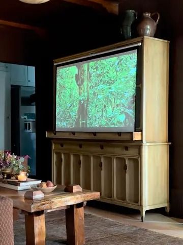 20 Ways to Stylishly Hide a TV in Plain Sight | domino How To Hide Tv In Bedroom, Ikea Hidden Tv Hack, Diy Hidden Tv, Hide A Tv, Hide Your Tv, Hide Tv, Tv Hacks, Tv Storage Unit, Dining Banquette