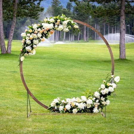 Are you looking for a way to enhance the charm and appeal of your special occasions? Look no further than our versatile wooden wedding arch! Available in round shapes, this exquisite arch is the perfect addition to any event. Whether you prefer flowers, string lights, balloons, or draping fabrics, the options are endless for creating a personalized and memorable ambiance that will leave a lasting impression on your guests. Besides, this wooden arch provides a sturdy and stable foundation, ensuring long-lasting durability for indoor and outdoor use. Whether you're celebrating a special milestone or creating a stunning photo backdrop, this wooden arch stand is the perfect choice for adding a touch of romance and sophistication to your gatherings. Feature Versatile round shape for unique eleg Diy Wedding Gazebo, Wooden Wedding Arch, Round Wedding Arch, Wooden Wedding Arches, Wood Arbor, Wooden Arbor, Outdoor Backdrops, Metal Wedding Arch, Wedding Arbor