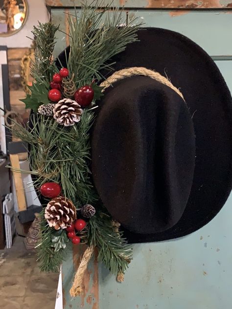 Taking that old cowboy hat and sprucing up for Christmas! Cowboy Hat Christmas Wreath, Cowboy Hat Wreath Diy, Decorating With Cowboy Hats, Western Farmhouse Christmas, Cowboy Christmas Hat, Cowboy Christmas Wreath, Western Winter Decor, Cowboy Christmas Trees, Western Christmas Wreaths