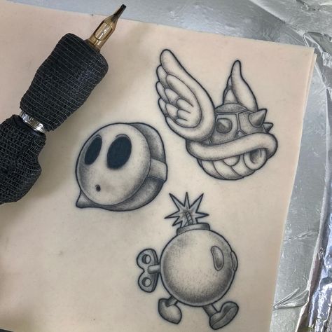 Shyguy Mario Tattoo, Mario Character Tattoos, Mario Theme Tattoo, Stippling Shading Tattoo, Bobomb Mario Tattoo, Small Shading Tattoo Design, Mario Flash Tattoo, Traditional Mario Tattoo, Stipple Shading Tattoo Design