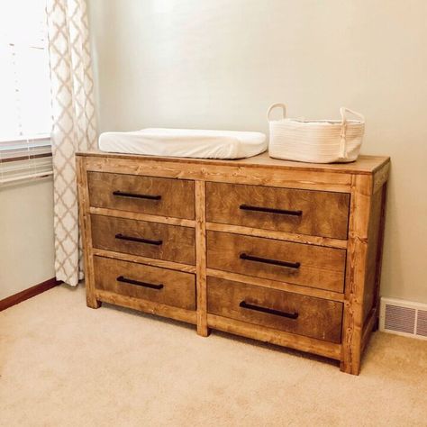 Hey there! If you saw my post about our DIY Farmhouse Crib a few months back, this is the dresser/changing table we built to go with it for our little one on the way! We used plans from Shanty2Chic for this dresser, so I won't go into too much detail, but we did make a couple changes. Changing Table From Dresser, Diy Farmhouse Dresser, Farmhouse Dresser Makeover, Farmhouse Crib, Farmhouse Cribs, Dresser Changing Table, Long Curtain Rods, Farmhouse Dresser, Baby Dresser