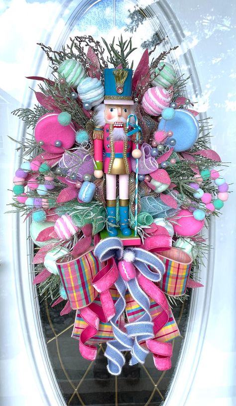 Nutcracker Christmas Bling Wreath, Holiday Pastel Swag, Gift for Her, Christmas Front Door Decoration, Holiday Gift, Sweets Wreath, Christmas Decorating Wood Pink Candy Cane Bling Rhinestone Nutcracker *white swag *premium deco mesh *17" wood pastel Blinged with rhinestones and tiny silver bells on his staff *Glittered pink bay leaf *Pastel Macarons  *Pastel yarn balls *snowy glittered greenery *green glittered pine picks  *Designer ribbon Measures 31"X23"X 8" Ready to ship! If you're happy with Pink Candy Cane Wreath, Nutcracker Ballet Christmas Tree Sugar Plum Fairy, Flamingo Christmas Wreath, Pastel Christmas Wreath, Pastel Nutcracker Christmas, Decorating With Nutcrackers Christmas, Nutcracker Door Hanger, Nutcracker Wreath Ideas, Nutcracker Wreaths