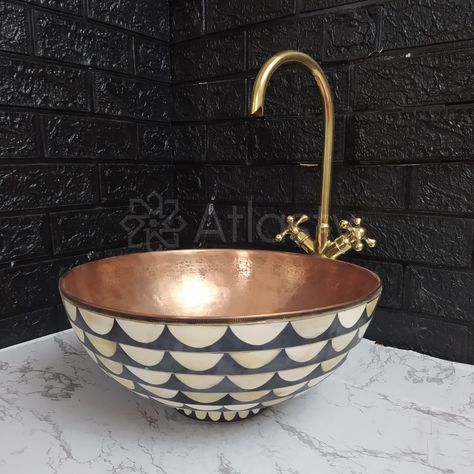 Give your bathroom a beautiful edge with the resin and copper vessel sink. This amazing piece will give your bathroom a unique look. Copper sinks will add liveliness to your space with their ability to match any design and style to create a joyful space that is uniquely yours. Offering a beautiful view and creative appeal to your house. The measures of these sinks can be customized depending on your vision. Features: - Easy Installation - Easy to clean - High-quality Moroccan construction - Material: Copper, Wood, Bone, Resin. - Black and White Pattern - Made of Solid Copper. - Unlacquered Copper finish. Gets a warm patina over time. - Warranty: Yes. - Premium wooden packaging Gifts: - Sink Strainer Dimensions: - Height: 6 in / 15 cm OR 7 in / 18 cm - Diameter: 16.5 in / 42 cm OR 15 in / 3 Bowl Sink Bathroom Vanities, Bowl Sink Bathroom, Vanity Vessel Sink, Copper Bathroom Sink, Colored Sinks, Copper Vessel Sinks, White Vessel Sink, Moroccan Sink, Antique Bathroom