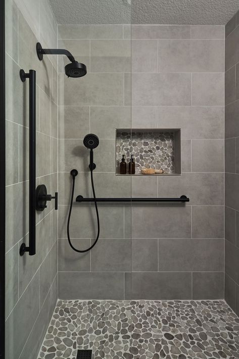 Bathroom Remodeling Ideas -  A transitional shower design with river rock floor and niche accent. Large format grey tile on the walls. Matte black fixtures. Makeover Kamar Mandi, Restroom Remodel, Tub To Shower Remodel, Full Bathroom Remodel, Bathroom Redesign, Bathroom Remodel Designs, Bathroom Remodel Shower, Bathroom Inspiration Decor, Shower Remodel