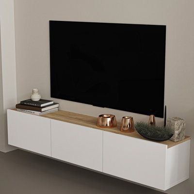 Introducing the Atelier Mobili Floating TV Console, a perfect solution for living room or bedroom TV stands. This floating media console is not only a functional piece but also a stylish addition to your home decor. It offers a modern, sleek, and space-saving design that will free up your floor space, making your room look bigger and more elegant. This floating console not only serves as a TV table but can also be used as a wall shelf, making it a versatile piece for your home. The under-TV floa Floating Cabinet Under Tv, Table Under Tv Decor, Under Mounted Tv Ideas, Decor Under Tv Wall Mounted Tv, Decor Under Tv, Shelf Under Tv, Wall Mount Tv Shelf, Entertainment Shelves, Floating Media Console