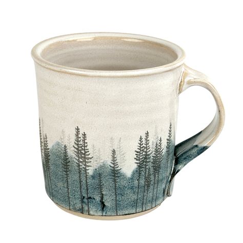 Artist: Red Bison Studio Approximately 4" tall x 4" wide This mug features a hazy blue mountain landscape behind several bunches of lodge pole pines. A bright large sun stands alone in the sky, and pearlescent glaze covers the inside and outside of the mug. Inspired by driving up a winding road into the Big Horn Mountains in Northern Wyoming. I hope this transports you to your favorite forested mountain spot. Food, dishwasher and oven safe, but it is actual gold on the mug so it is not microwava Mountain Mug Pottery, Mountain Mugs, Ceramic Mountain, Elk Silhouette, Mountain Mug, Line Artist, Mountain Tree, Mountain Pottery, Pottery Glaze