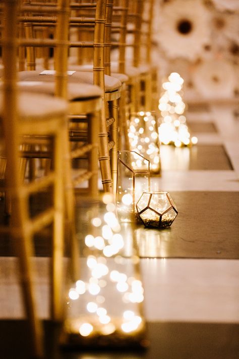 This fairy light lit lantern wedding aisle would look beautiful at a wedding at NOAH'S Event Venue. Fairy Lights Aisle Wedding, Fairy Lights Wedding Ceremony, Isle Decorations Wedding Indoor, Wedding Aisle Inspiration, Wedding Aisle Lights, Indoor Wedding Aisle Decor, Wedding Isles Decoration Indoor, Wedding Lanterns Aisle, Lantern Wedding Aisle