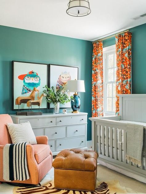 Blue and orange nursery features walls painted blue, Sherwin Williams Riverway, lined with a light gray crib, Bassett Chesapeake Full Panel Crib, dressed in white and gray crib bedding flanked by windows dressed in orange and turquoise blue curtains, DwellStudio Vintage Plumes Fabric. Neutral Nursery Colors, Nursery Inspiration Boy, Orange Nursery, Gender Neutral Kids Room, Eclectic Nursery, Neutral Kids Room, Nursery Pictures, Adorable Nursery, Nursery Colors