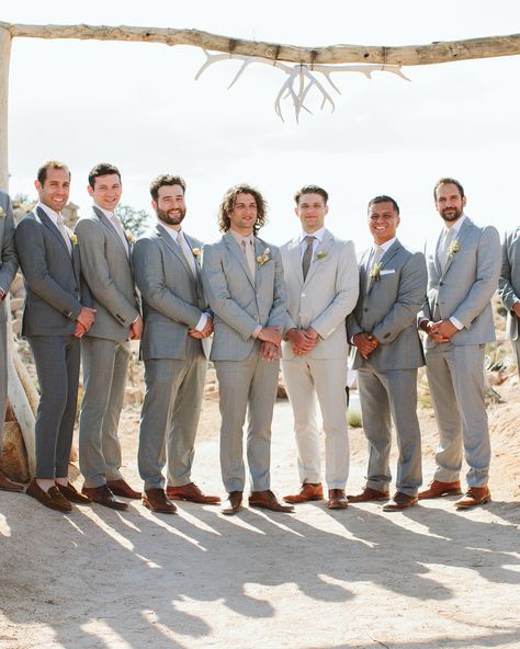 Basil's groomsmen—his two brothers, high school friends, and Ashley's sister's fiancé—looked sharp in light gray suits, neutral shirts and ties, and brown shoes. Gray Suit Groomsmen, Light Gray Suits, Bohemian Reception, Neutral Shirts, Mismatched Groomsmen, California Desert Wedding, Light Gray Suit, Gray Groomsmen Suits, High School Friends