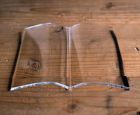 Glass Book Page Holder is a transparent piece of glass shaped like a book that holds the pages of your book down while you read through it and was created by a Japanese company called Tent. The glass book holder is great for when you need to eat cheeseburgers and/or sip cola from a big gulp while reading, so the glass will hold your pages for you while you fatten up and learn how to lose weight :) Pin if you like it! :) #books #pageholder Glass Book, Buch Design, Transparent Paper, Book Holders, Book Stands, Japan Design, Open Book, Japanese Design, Everyday Objects