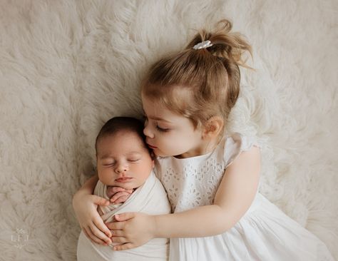 newborn Boy with toddler big sister kissing his forehead in Nj photography studio Newborn Sibling Pictures Studio, Sibling Photography Newborn Big Sister, Newborn Photos With Older Sister, Newborn And Toddler Photoshoot, Newborn And Sister Photography, Newborn Sister And Big Sister, Baby And Toddler Photoshoot, Sibling Newborn Pictures Big Sister, Toddler And Newborn Photoshoot