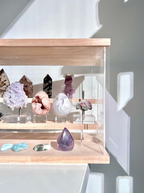 "Not sure how to organize your crystals and minerals? Tired of dusting your crystals and minerals? Need more space on your shelf or desk? Need your crystal display to be more organized? These crystal display cases were specifically designed and created by The Stone Queen Co for storing & displaying all of your precious crystals and minerals. There are three neutral colors to choose from - wood, white and black. Featuring a sleek, simple and elegant design, this is the perfect accessory for your crystal display.    --- Made from acrylic and wood materials. --- The front panel slides L to R and can be completely removed for easy access to the shelves. --- There are 2 inner shelves that run from left to right and sit flush with the walls. --- The top shelf sits flush with the back wall (aka n Crystal Organization, Crystal Display Shelf, Crystal Storage, Crystal Room Decor, Crystal Stand, Crystal Room, Crystal Shelves, Crystal Holder, Displaying Crystals