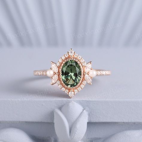 Vintage Oval Green Sapphire Pearl Engagement Ring Art Deco Filigree Solid Gold Wedding Ring Unique Birthstone Ring Anniversary Gift Handmade PRODUCT SUMMARY Metal Type: yellow, white or rose solid 14 or 18k gold. Size: All sizes are available, contact me if they do not contain the size you want in the drop-down menu. ☪☪Engagement ring ⚜Center Stone - Lab Grown Olive Green Sapphire Cut - Oval Size - 7x5mm ⚜Side Stone - Moissanite Cut - Round Weight - 0.33ct Clarity - SI-VS Color- G-H ⚜Band width - 1.8mm IMPORTANT INFORMATION  ☪Shipping ⚜It usually takes 2-3 weeks for production and 2-5 days for shipping to most US destinations. Free shipping within US. ⚜If you want to receive your ring sooner, rush order and shipping upgrade services are available. ☪Engraving You can order a custom engravin Vintage Green Ring, Gold And Emerald Wedding Ring, Non Traditional Wedding Rings Vintage, Art Deco Ring Engagement, Subtle Engagement Rings, Emerald Green Wedding Ring, Oval Vintage Engagement Ring, Engagement Rings Pearl, Wedding Ring Pearl