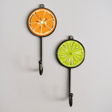 These fresh citrus fruit hanging slices coat hooks are the perfect accessory for hanging your scarf, coat and cloths in a hallway or bedroom. Great as a house warming gift, birthday present or maybe a treat for yourself. These hooks can hold up to 10kg in weight and are perfect for bags, coats, towels and any other accessories. These hooks are sold separately. Made from a Gunmetal Black base and hook with acrylic printed insert. Hook Colour: Dark Chrome Returns: please return your order within 2 Citrus Bathroom, Citrus Kitchen, Fruit Kitchen Decor, Scarf Coat, Bathroom Themes, Fruit Slice, Hanging Towels, Hanger Hooks, Kitchen Themes