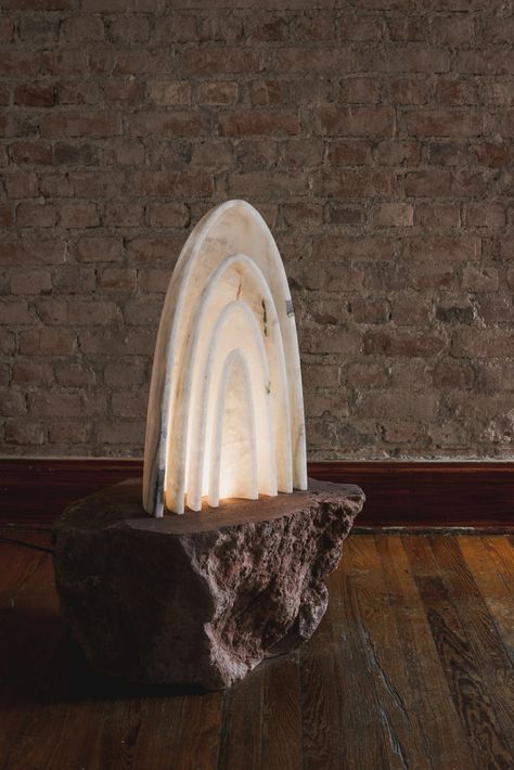 Mexico-based EWE Studio handcrafts one-of-a-kind sculptural furniture, lighting, and artworks. We have previously seen Alquimia home collection made from volcanic rock from them, now the studio is back with the Aura white onyx stone lamp. This piece of art is influenced by the religious elements, objects and places of worship. Lightning Fixture, Natural Stone Lamp, Marble Stools, Alabaster Floor Lamp, Mustard Armchair, Alabaster Table Lamp, Aura White, Onyx Lamp, Rock Lamp