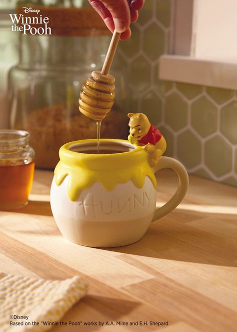 Start any day with a smackerel of sweetness with this cute Winnie the Pooh sculpted mug. Ceramic cup of a hunny pot features Pooh sitting on the rim, ready to swipe a pawful of honey. Perfect for cocoa, coffee and hot tea (especially when you add honey), this 17-ounce cup makes a delightful gift for a Winnie the Pooh fan. Sculpted ceramic mug features Disney Winnie the Pooh sitting on a honey pot. On mug: HUNNY. Ceramic. Dishwasher safe. Do not microwave. Holds 17 oz. 5.5" W x 4.75" H x 3.25" D Cute Mug Set, Mug Cute Design, Winnie The Pooh Mugs, Winnie The Pooh Ceramics, Cup Clay Art, Winnie The Pooh Merchandise, Tea Pot Ceramic Ideas, Disney Ceramics Ideas, Winnie The Pooh Pottery