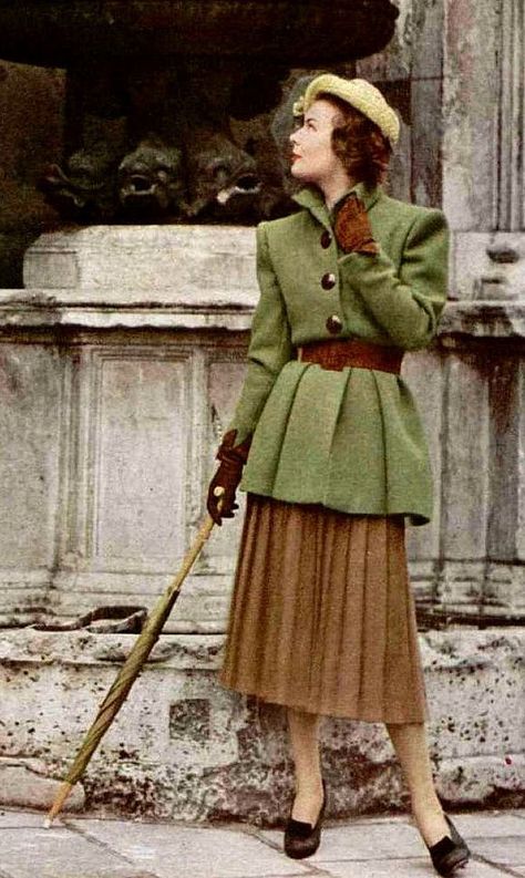 1947 Model is wearing a long moss-green belted jacket over brown pleated skirt by Jacques Fath late 40s winter wear casual day jacket skirt hat shoes gloves belt green brown tan wool warm 40s Mode, 1940s Fashion Women, Brown Pleated Skirt, Jacques Fath, Mode Retro, Fashion 1940s, Design Moda, 20th Century Fashion, Brown Skirt